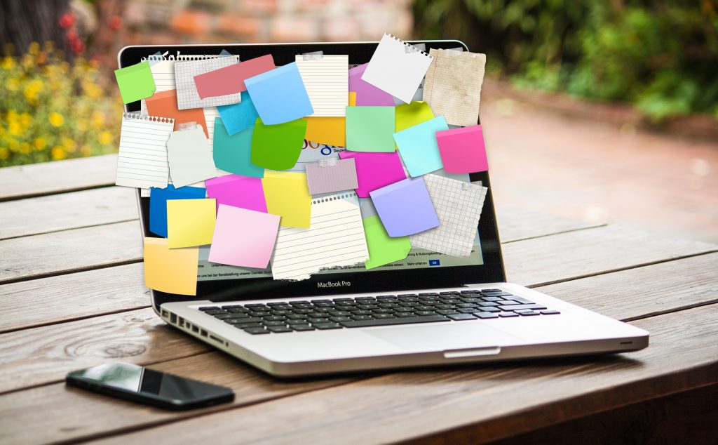 Macbook covered in sticky notes