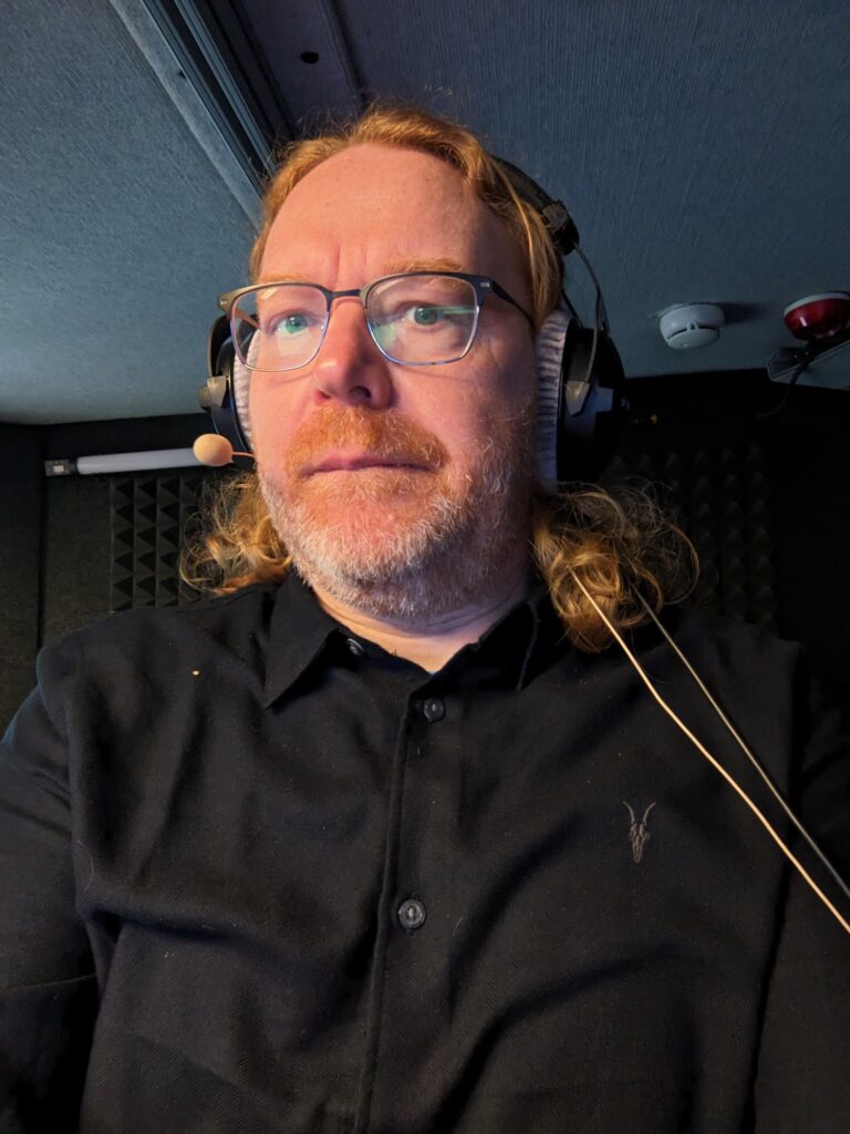 Chris wearing headset and microphone